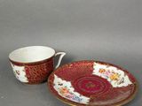 a close up of a cup and saucer on a table