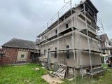 a picture of a house being built with scaffolding