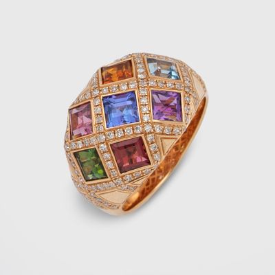 a close up of a gold ring with multi colored stones
