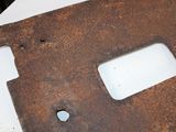 a piece of rusted metal sitting on a table