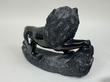 statue of a man sitting on a rock with his head in his hands