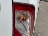 a close up of the tail light of a white truck