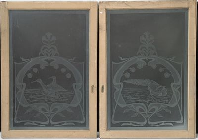 two etched glass windows with a picture of a boat in the water