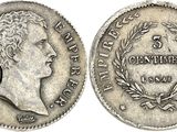 a silver coin with the head of a man on it