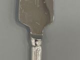 a silver knife that is sitting on a table