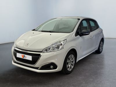 the small white car is parked in a large room