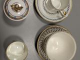 four cups and saucers sitting on a table