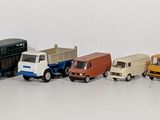 a lot of toy trains that are lined up on a table