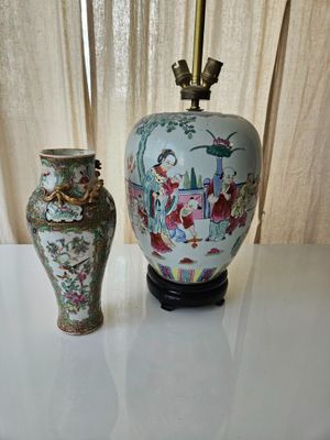 two vases sitting on a table next to each other