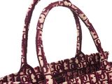 purple and white handbag on white background with red and white letters