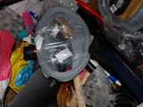 a pile of assorted items in a cluttered room