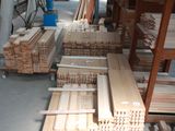 many stacks of wooden planks in a warehouse