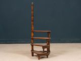 a wooden chair that is sitting in the middle of a room
