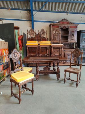 several pieces of furniture are sitting in a room with a lot of boxes