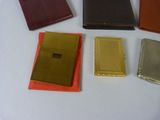 five different colors of wallets sitting on a table