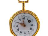 a gold pocket watch with roman numerals on it