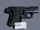 a gun that is on a table with a price tag