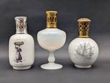 three white vases sitting next to each other on a gray surface
