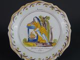 a plate with a picture of a man sitting on a bench