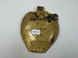 a gold apple with a cat on top of it