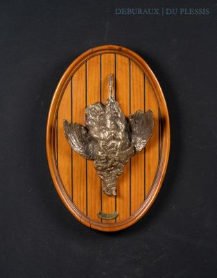 a wooden plaque with a bird on it on a wall