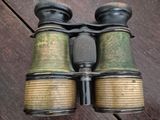 a pair of binoculars sitting on a wooden floor