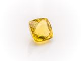 a yellow sapphire stone on a white background