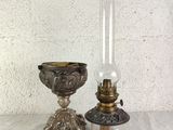 pair of antique brass candlesticks and oil lamp on marble table