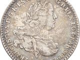 a silver coin with a woman ' s head on it