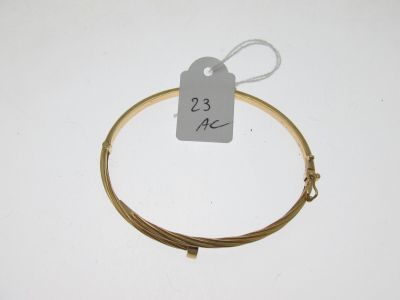 a close up of a wire bracelet with a price tag on it