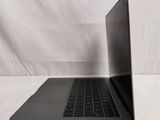 an open laptop computer sitting on top of a white surface