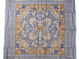 a blue and yellow square scarf with a floral design