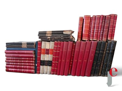 several old books stacked on top of each other on a white surface