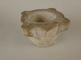 a stone vase that is sitting on a table
