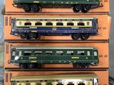 three green and yellow train cars are stacked on top of each other