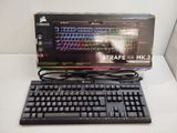 a computer keyboard and a mouse on a table