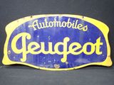 un panneau bleu et jaune sur lequel on peut lire « Automobil's Peupet »