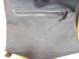 a blue bag with a zipper on it sitting on a table