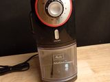 a black and red blender on a wooden table