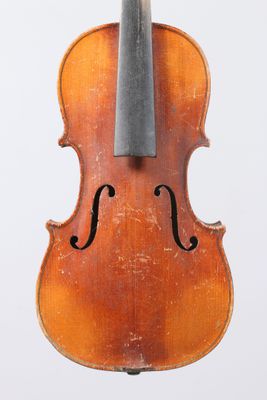 an old violin with a bow hanging from it ' s back