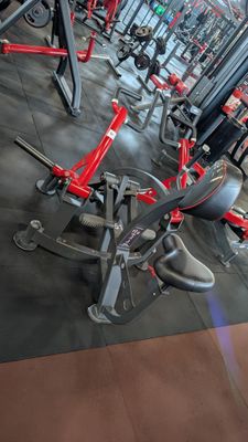 a gym with a lot of machines in the room