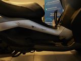 a motor scooter that is parked in a room