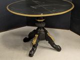 an image of a black and gold table on a white floor