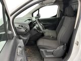 the interior of a white van with the door open and the driver ' s seat down