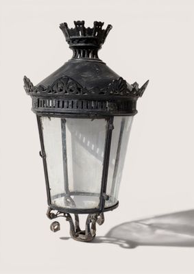 a black lamp with a crown on top of it