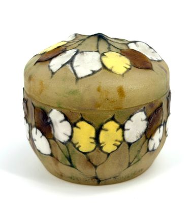 a small box with flowers on it on a white surface