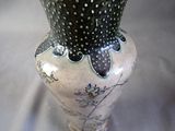 a black and white vase sitting on a table