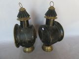 two black and gold fire hydrants sitting on a table