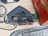 a picture of a corded sander and other tools on a table
