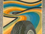 an advertisement for a tire with a colorful swirl pattern on it